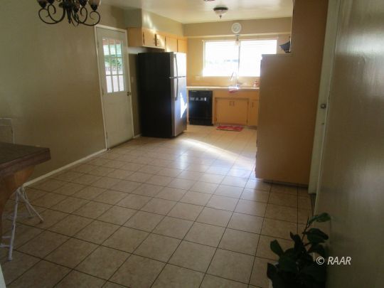 232 South Silver Ridge Street Ridgecrest, CA 93555 - Photo 9 of 19 a view of a refrigerator and window in a kitchen