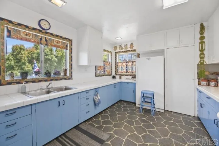 1660 Burgundy Road Encinitas, CA 92024 - Photo 11 of 25 a large bathroom with a double vanity sink and a large mirror