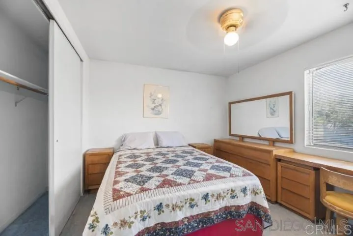 1660 Burgundy Road Encinitas, CA 92024 - Photo 22 of 25 a bedroom with a bed and a window