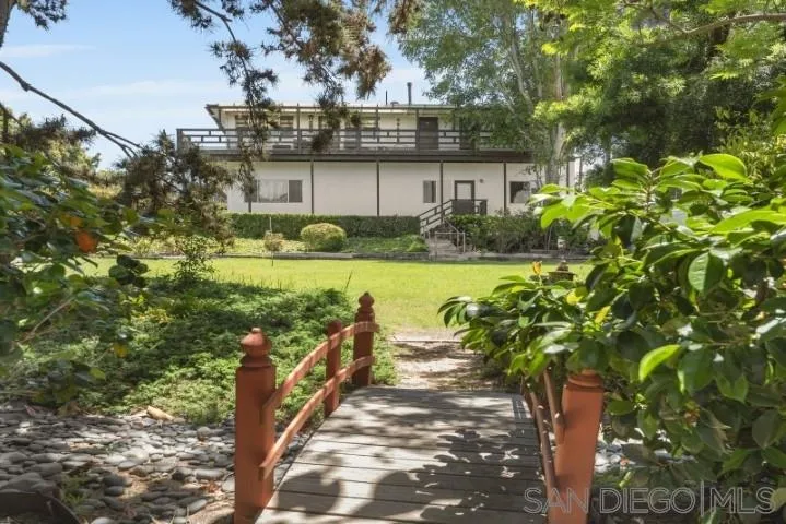 1660 Burgundy Road Encinitas, CA 92024 - Photo 23 of 25 a view of a garden with a bench in front of house