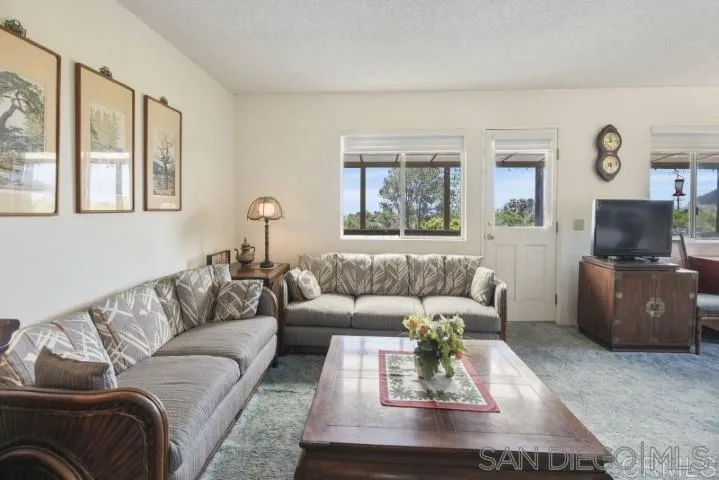 1660 Burgundy Road Encinitas, CA 92024 - Photo 3 of 25 a living room with furniture and a flat screen tv