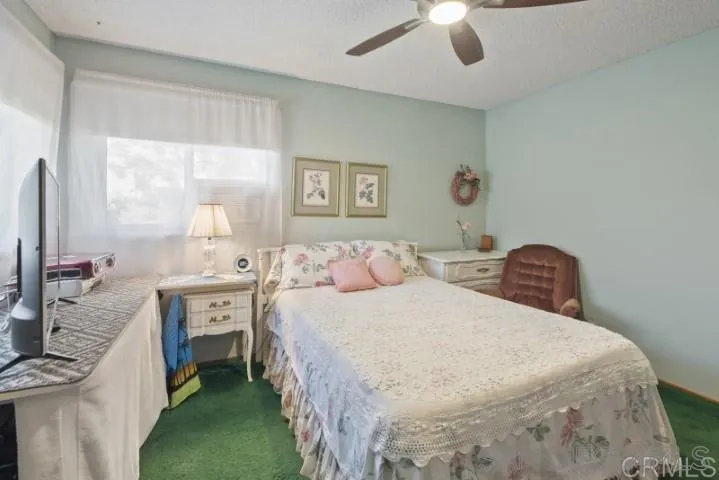 1660 Burgundy Road Encinitas, CA 92024 - Photo 7 of 25 a bedroom with a bed and a chandelier