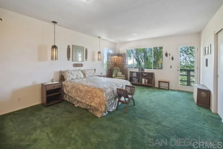 1660 Burgundy Road Encinitas, CA 92024 - Photo 8 of 25 a bedroom with a bed dresser and a window