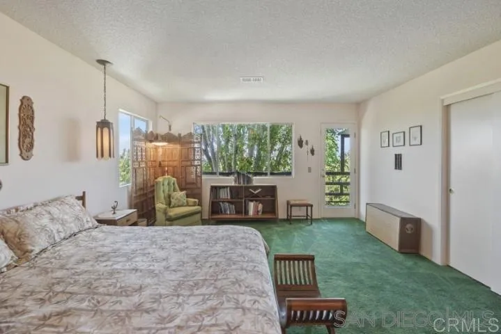 1660 Burgundy Road Encinitas, CA 92024 - Photo 9 of 25 a living room with furniture and a floor to ceiling window