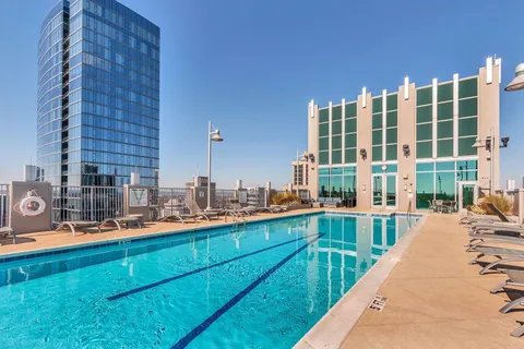 a swimming pool with outdoor seating and yard