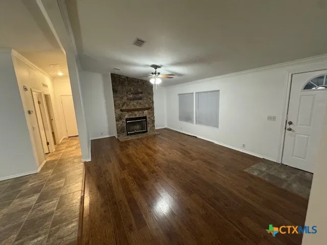 wooden floor in an empty room with a fireplace