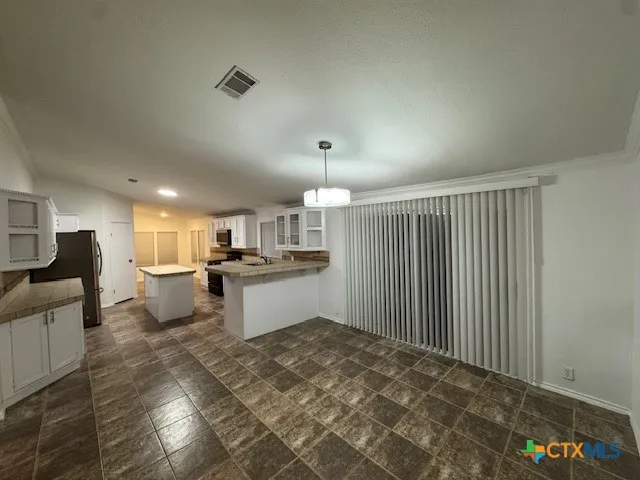 a open kitchen with kitchen island a sink dishwasher a stove and a refrigerator with wooden floor