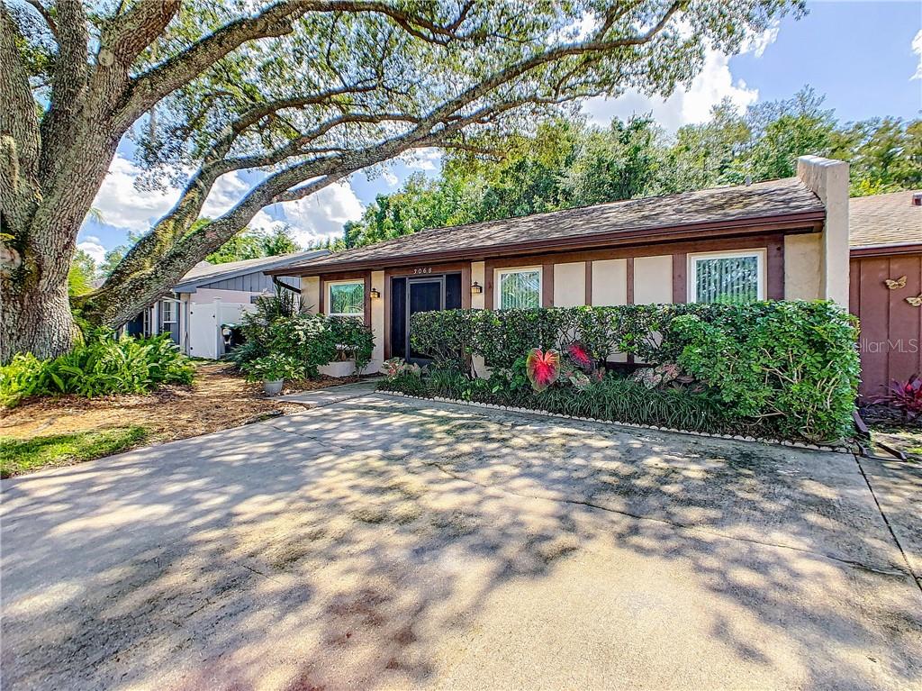 3068 Stonecastle Road Orlando, FL 32822 - Photo 1 of 1 a front view of house with yard and trees around
