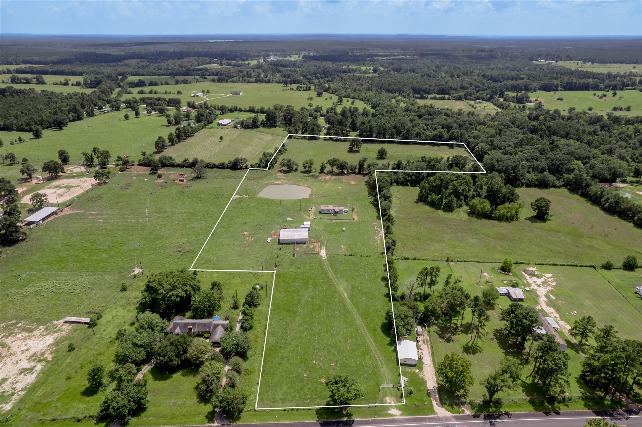 an aerial view of a golf course with a lake view