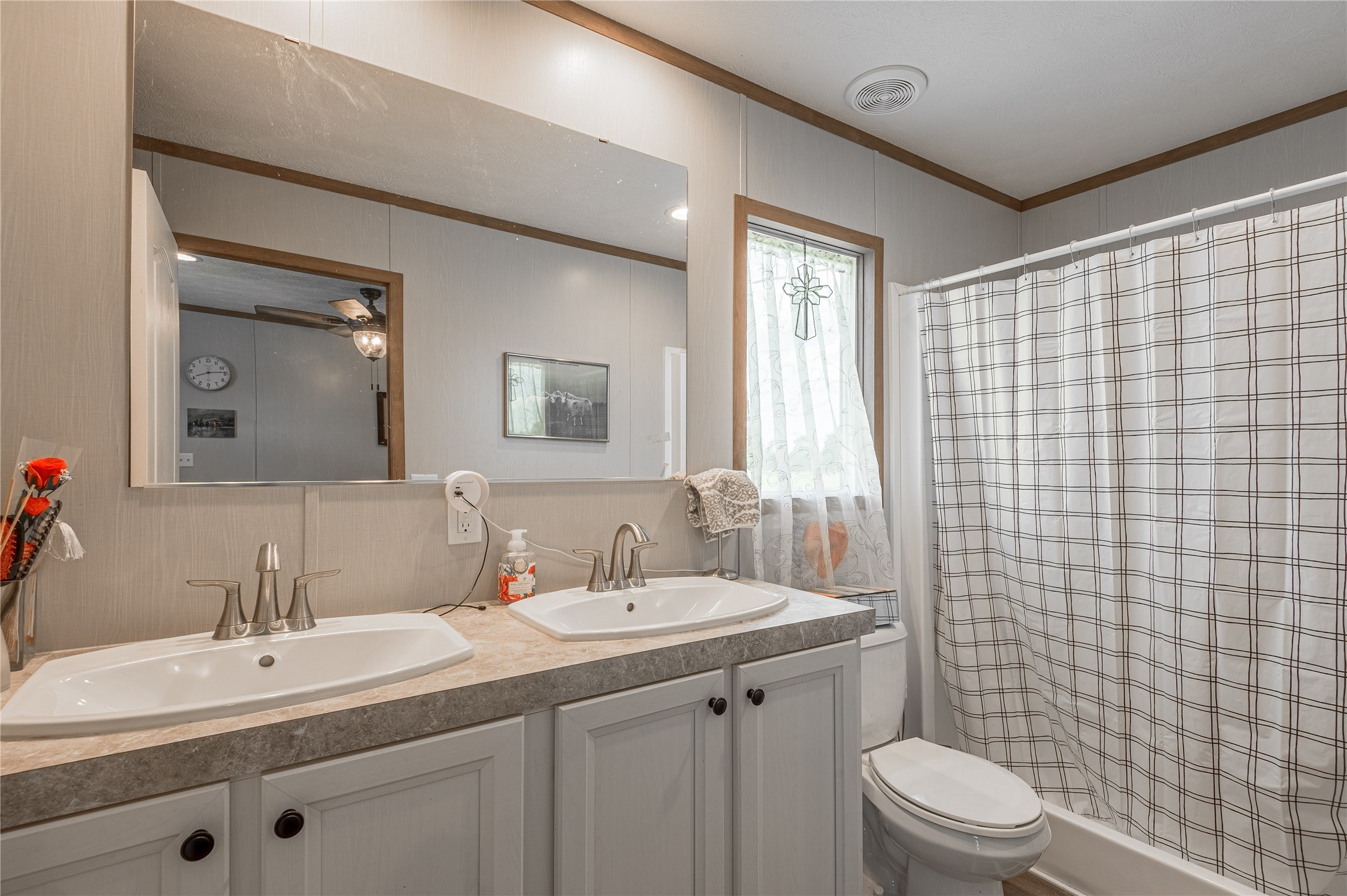 998 East 1st Street Groveton, TX 75845 - Photo 11 of 25 a bathroom with a double vanity sink toilet and shower