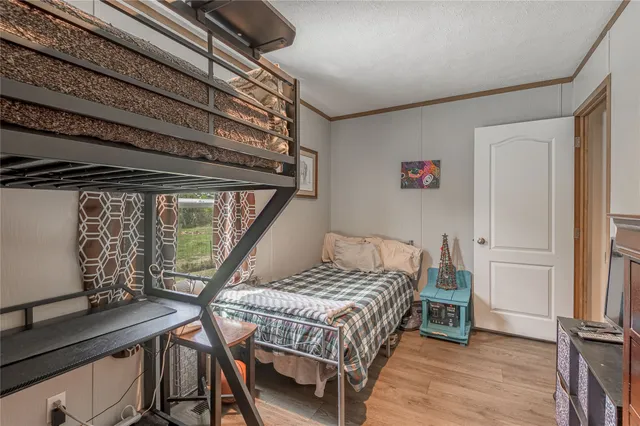 a bedroom with a bed next to a window