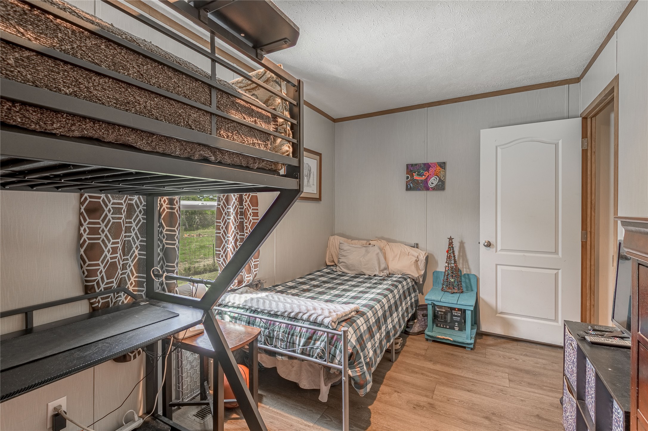 998 East 1st Street Groveton, TX 75845 - Photo 13 of 25 a bedroom with a bed next to a window