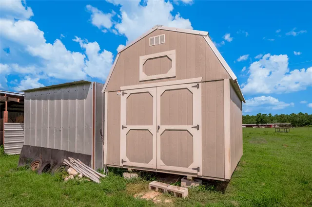 a view of a tiny house with garden
