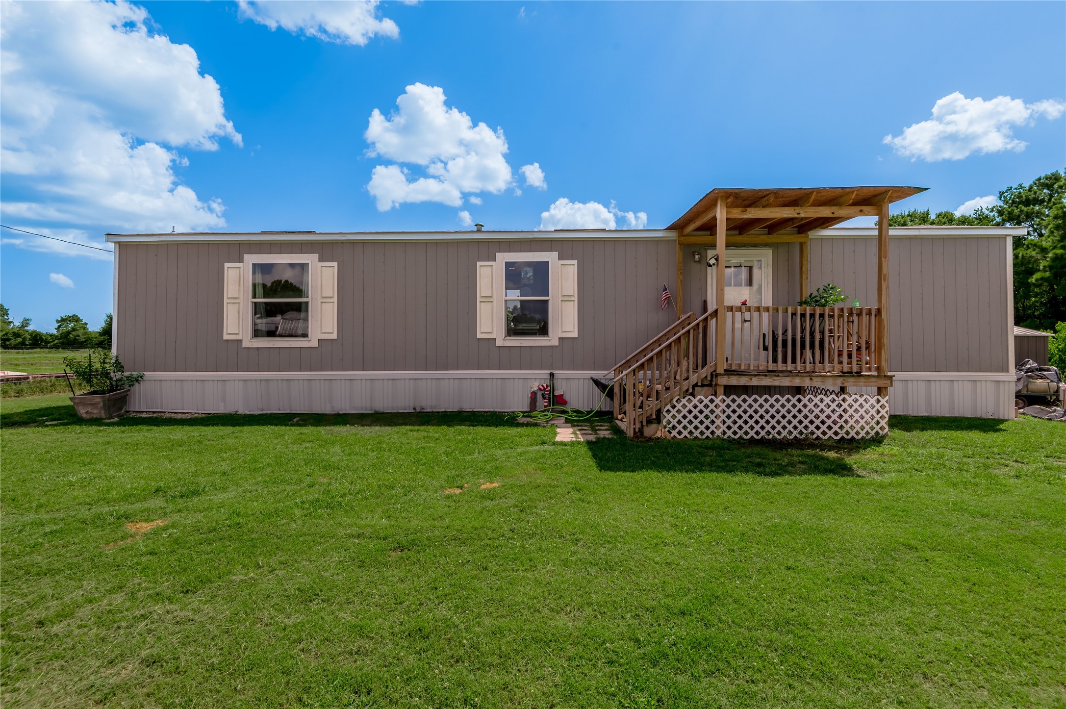 998 East 1st Street Groveton, TX 75845 - Photo 2 of 25 a view of a house with backyard and garden