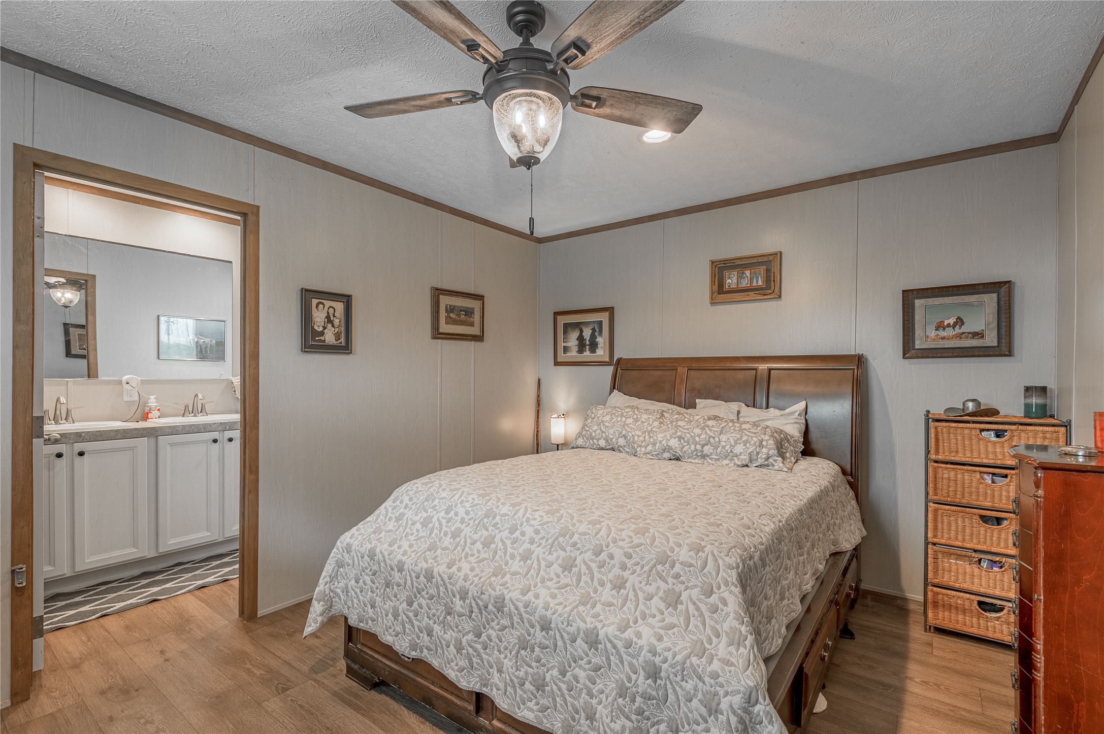 998 East 1st Street Groveton, TX 75845 - Photo 10 of 25 a bedroom with a bed and a chandelier
