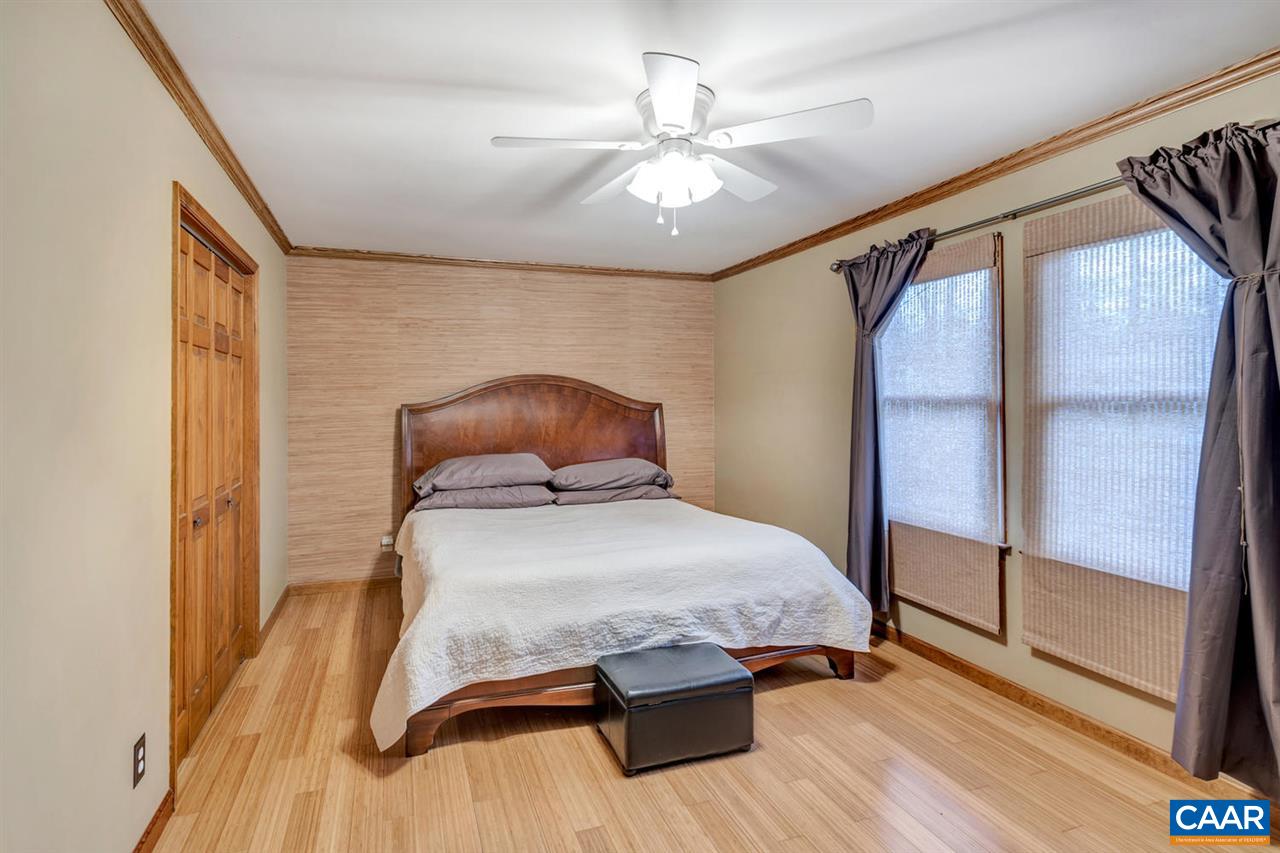 66 Laguna Road Palmyra, VA 22963 - Photo 14 of 50 a bedroom with a bed and a chandelier