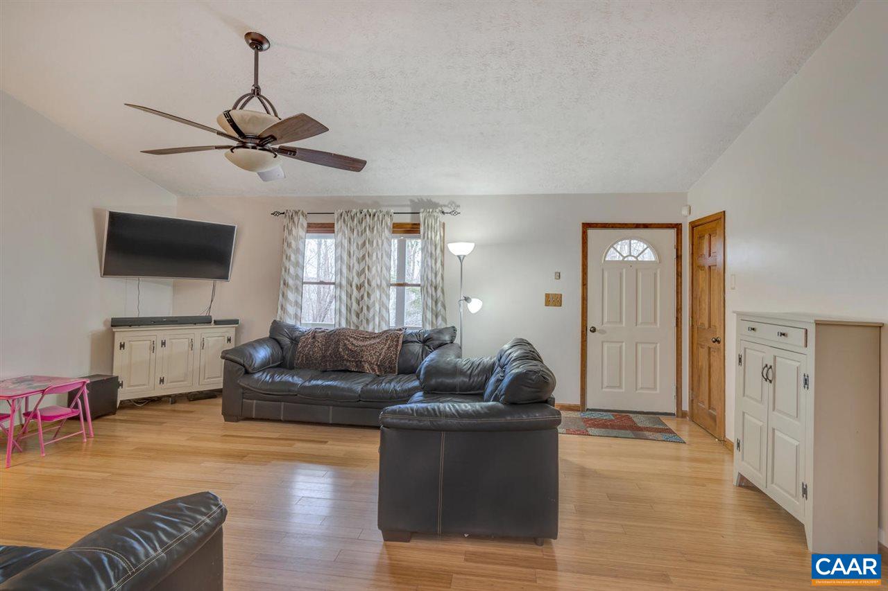 66 Laguna Road Palmyra, VA 22963 - Photo 7 of 50 a living room with furniture and a flat screen tv