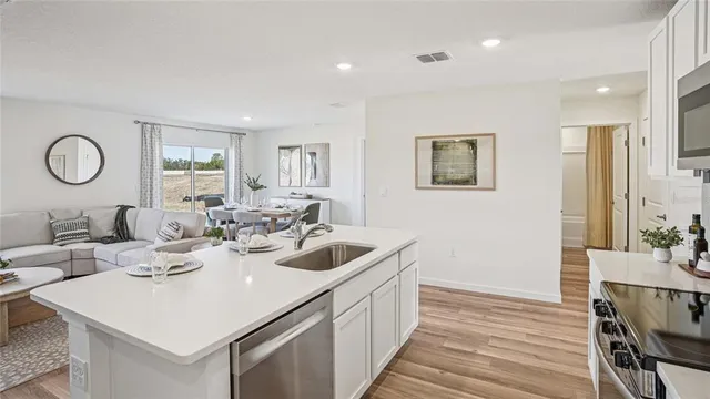 a kitchen with a sink and a refrigerator