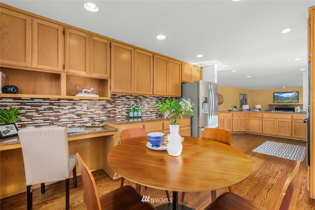 4603 Northeast 19th Street Renton, WA 98059 - Photo 14 of 30 a kitchen with a dining table chairs and white cabinets