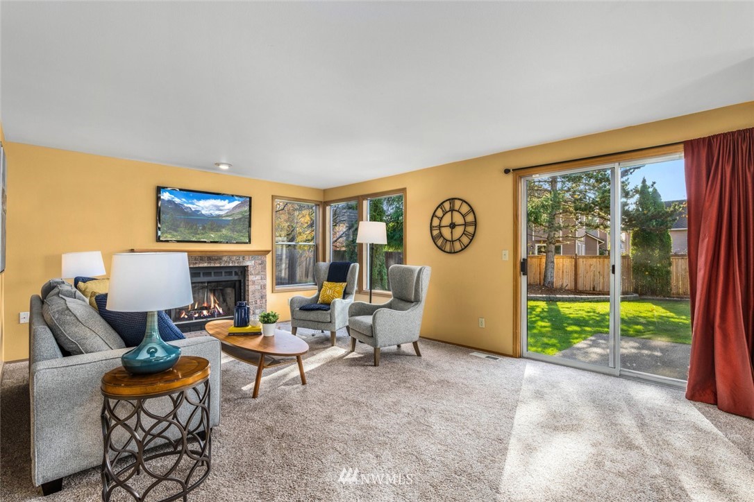 4603 Northeast 19th Street Renton, WA 98059 - Photo 15 of 30 a living room with furniture a fireplace and a large window