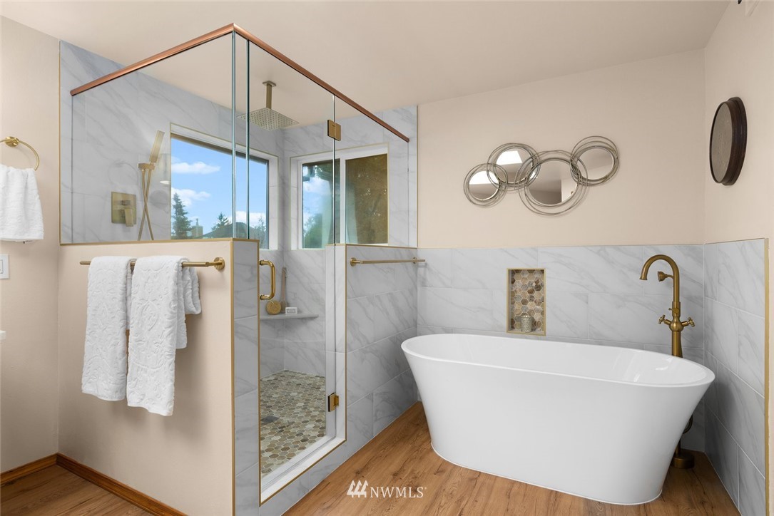 4603 Northeast 19th Street Renton, WA 98059 - Photo 21 of 30 a bathroom with a sink a mirror and shower