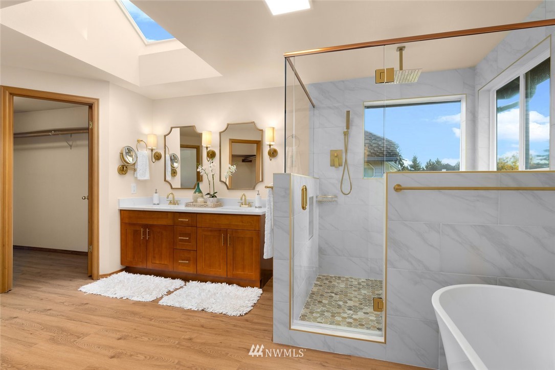 4603 Northeast 19th Street Renton, WA 98059 - Photo 22 of 30 a bathroom with a granite countertop sink a mirror and shower