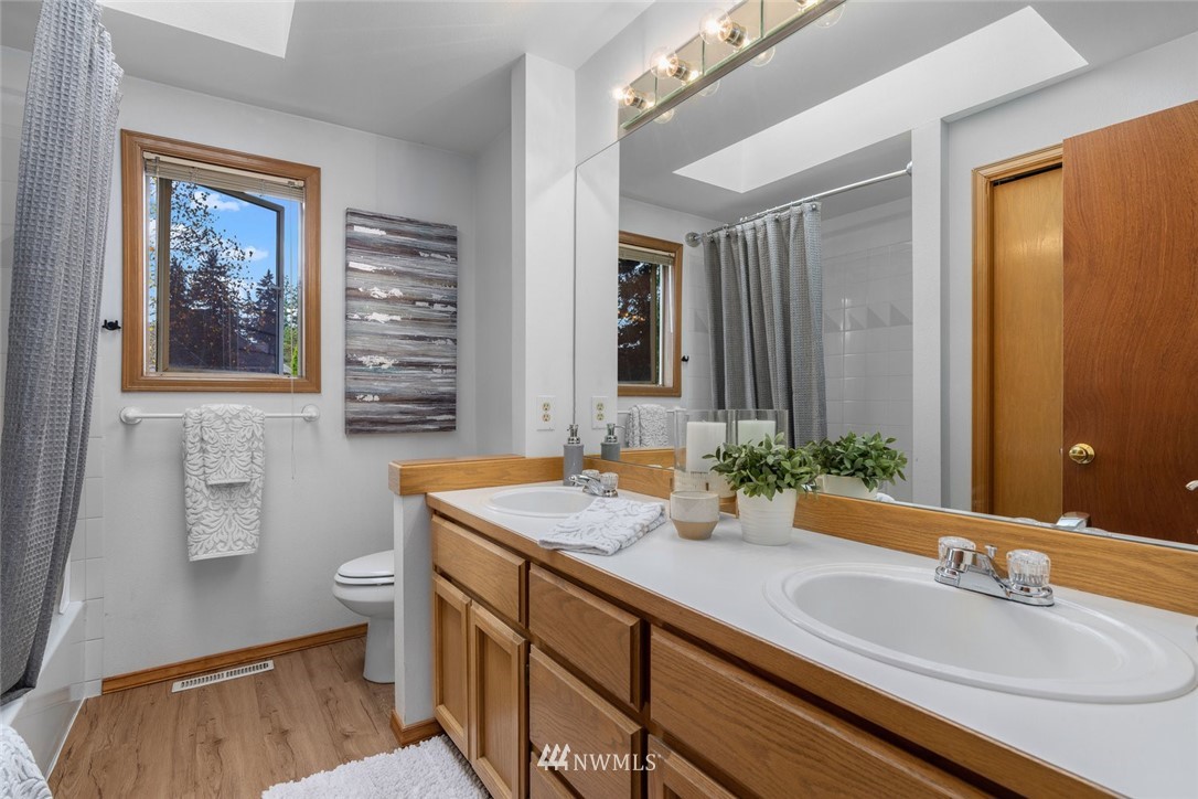 4603 Northeast 19th Street Renton, WA 98059 - Photo 24 of 30 a bathroom with a sink double vanity granite and a window