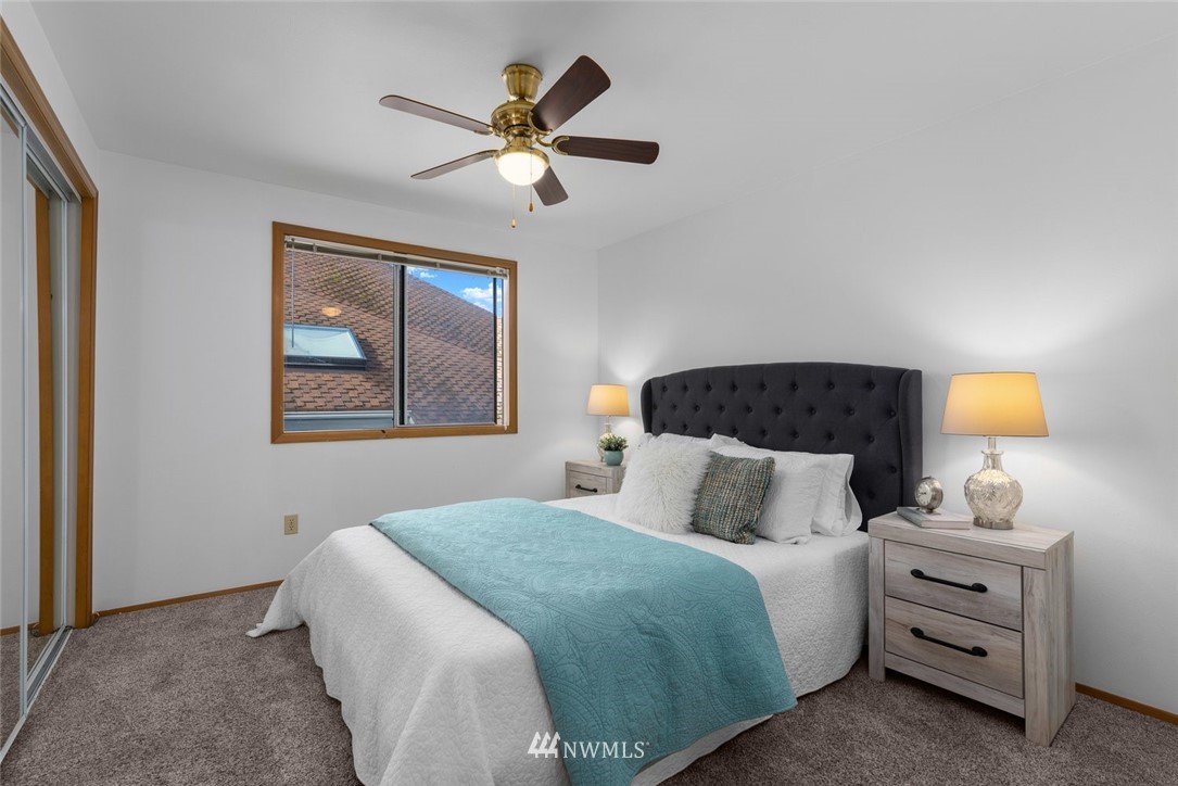 4603 Northeast 19th Street Renton, WA 98059 - Photo 25 of 30 a bedroom with a bed and a lamp on dresser