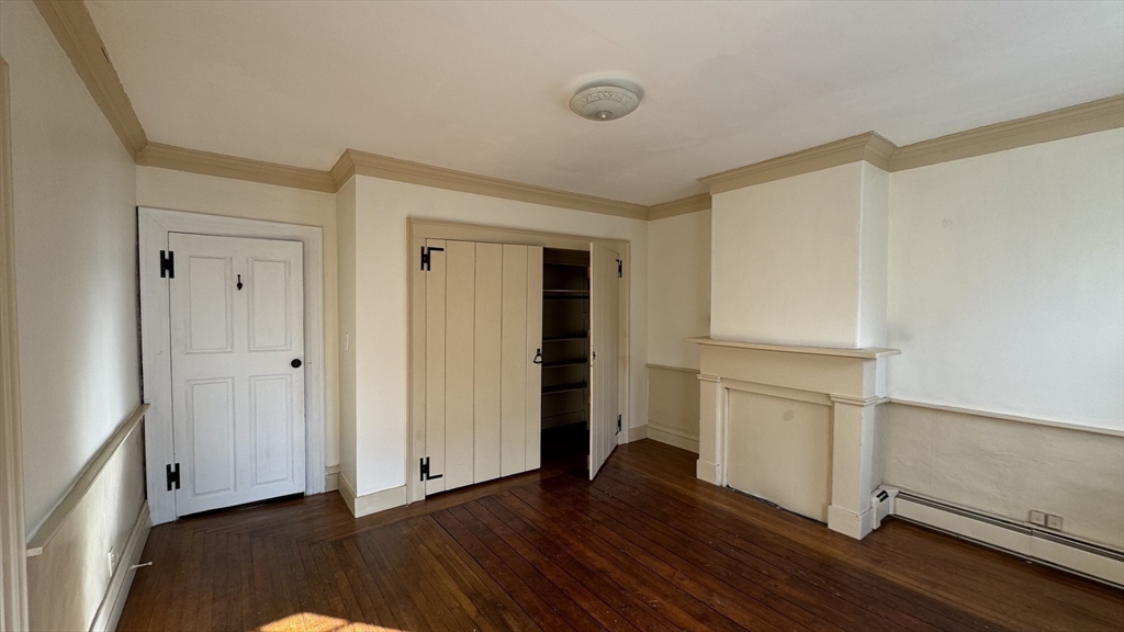 18 State Street, Unit 1 Marblehead, MA 01945 - Photo 12 of 16 a view of an empty room with wooden floor and a window