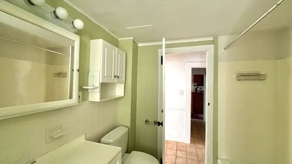 a bathroom with a toilet shower and a sink