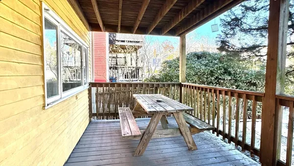 a view of a balcony with wooden floor