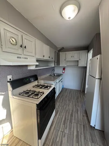 a kitchen with cabinets and a stove