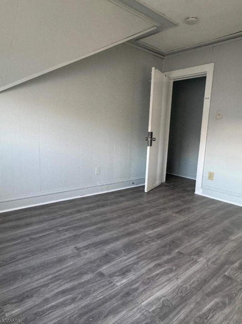 467 21st Avenue Paterson, NJ 07513 - Photo 5 of 7 a view of an empty room with wooden floor and closet