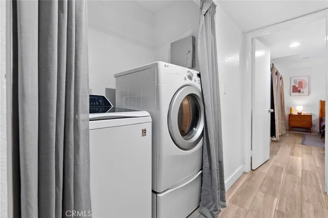 a hallway with seating space and stainless steel appliances