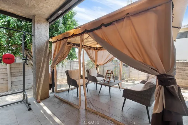 a view of a balcony with wooden floor and chair