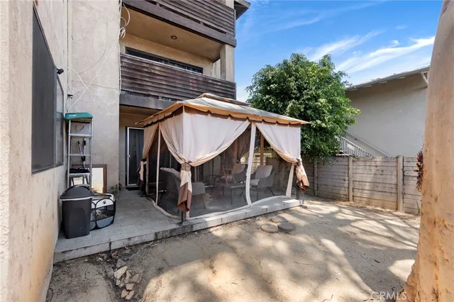a view of a patio with couches table and chairs and potted plants