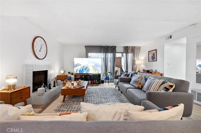 a living room with furniture and a fireplace