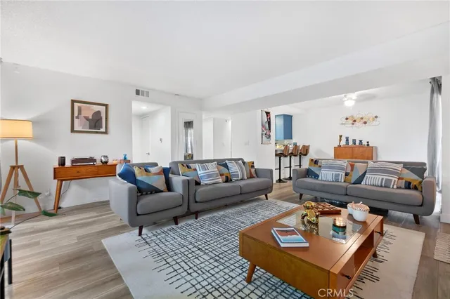 a living room with furniture a rug and a window
