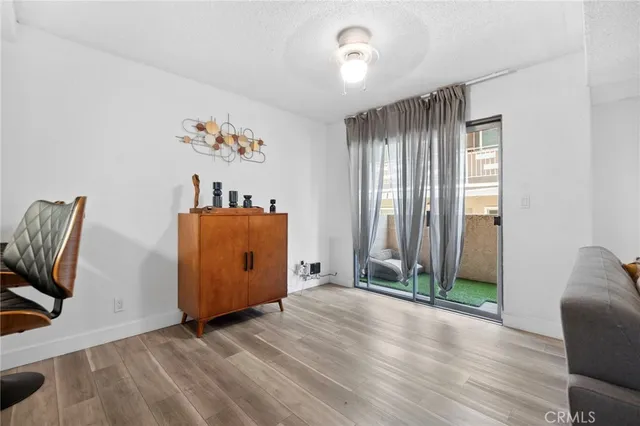 a view of a livingroom with wooden floor and closet