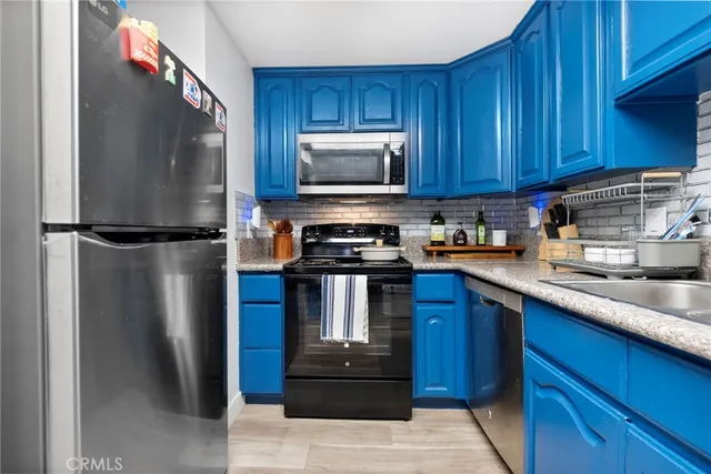 a kitchen with a refrigerator sink and microwave