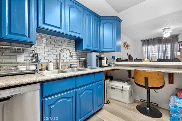 a kitchen with a sink stainless steel appliances and cabinets