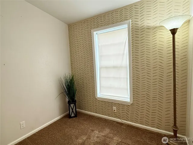 a bathroom with a granite countertop toilet sink and mirror