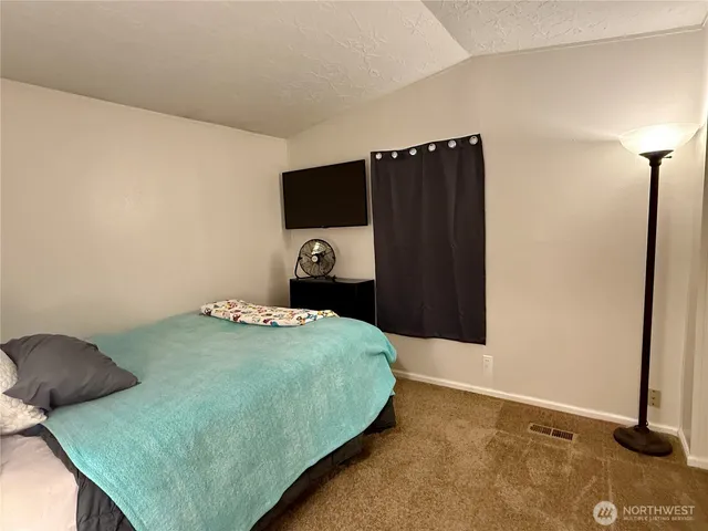 a bedroom with a bed and a dresser