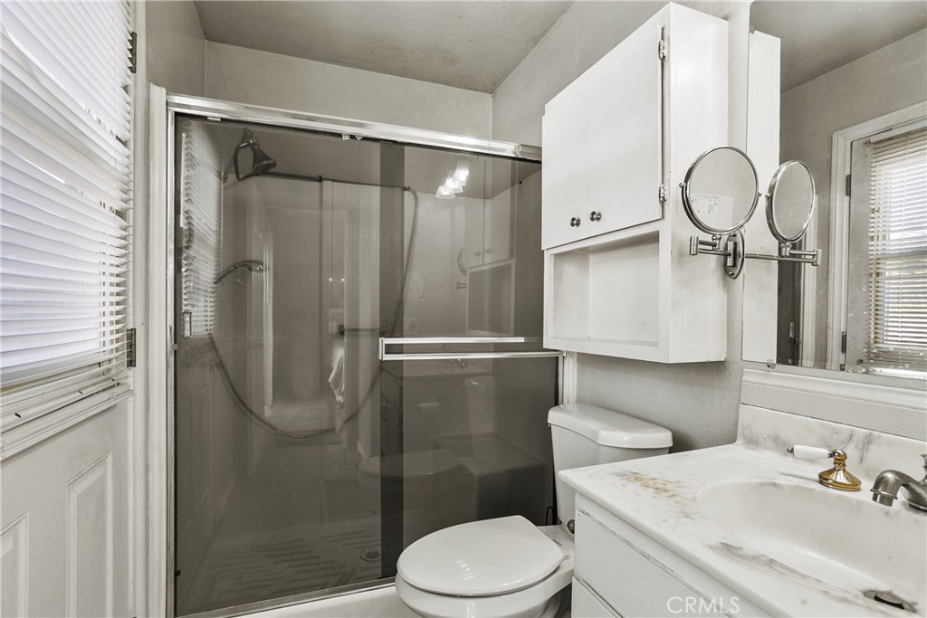 4801 Redbluff Circle Irvine, CA 92604 - Photo 14 of 34 a bathroom with a toilet a sink and shower