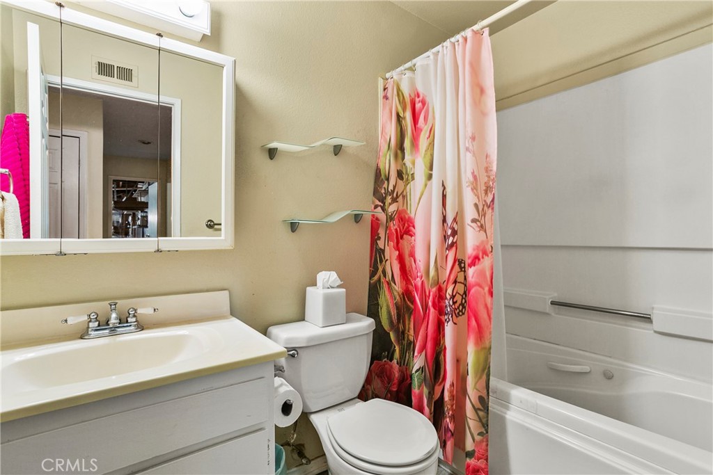 4801 Redbluff Circle Irvine, CA 92604 - Photo 16 of 34 a bathroom with a sink a toilet and shower curtain