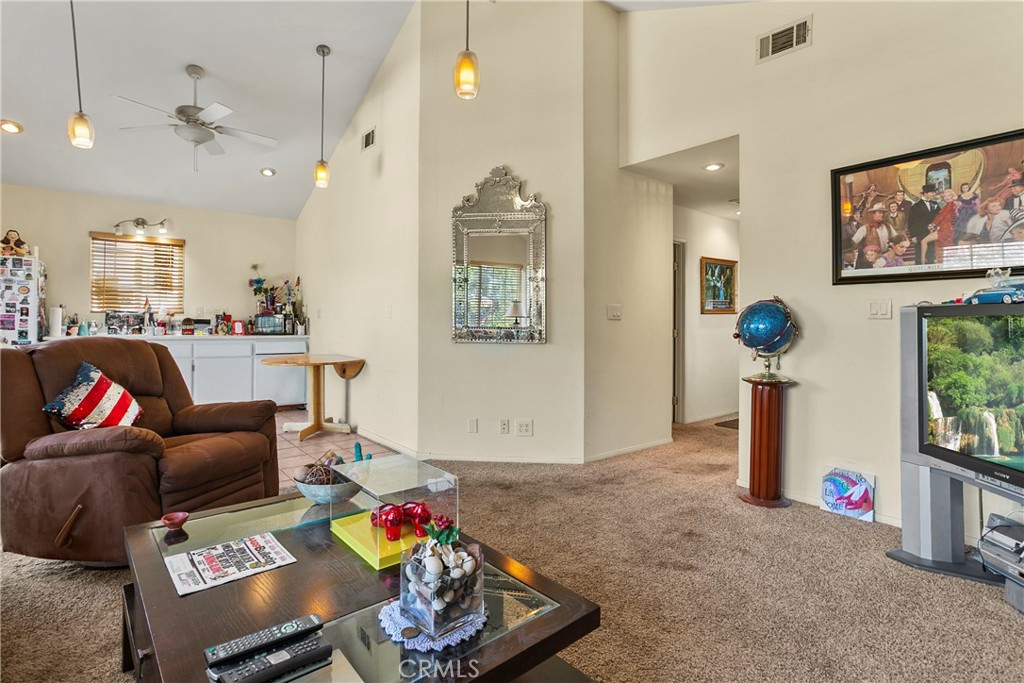 4801 Redbluff Circle Irvine, CA 92604 - Photo 21 of 34 a living room with furniture and a chandelier