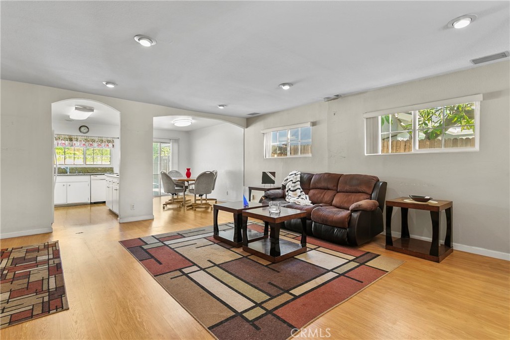 4801 Redbluff Circle Irvine, CA 92604 - Photo 5 of 34 a living room with furniture a wooden floor and a large window