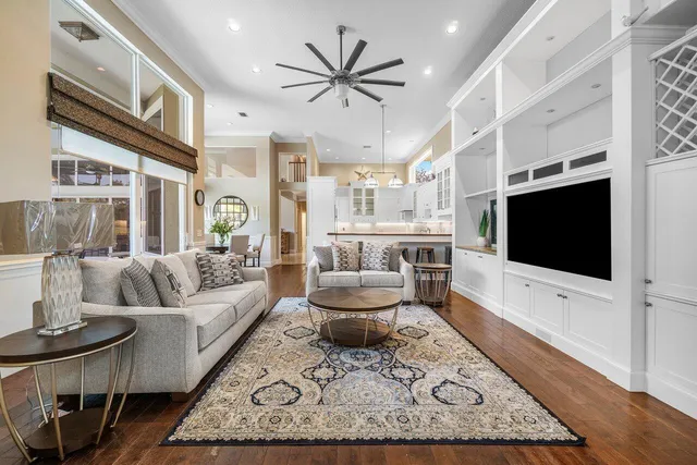 a living room with a bed and a chandelier