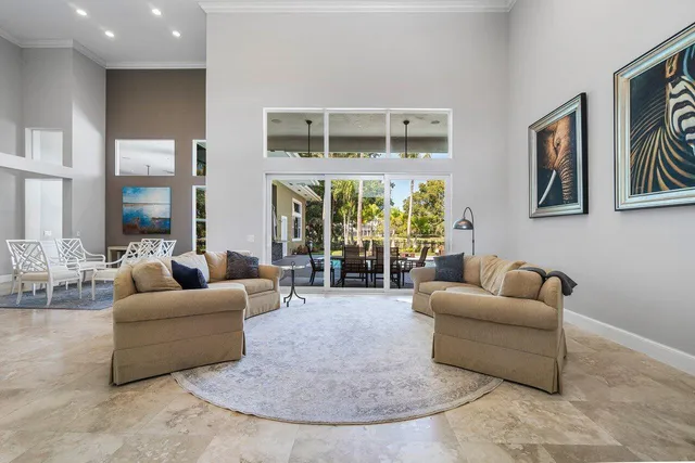 a living room with furniture and a floor to ceiling window