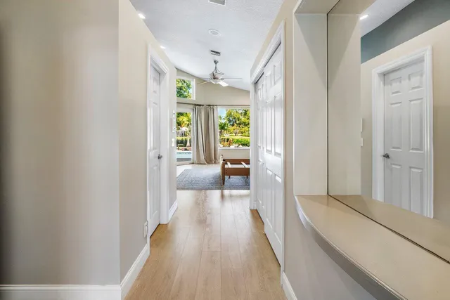 an aerial view of residential houses with outdoor space and lake view